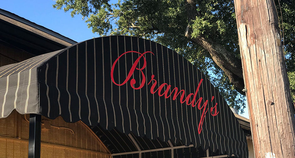 awnings signs, hand painted awnings, awning lettering, sunbrella awning covering new orleans nola , metal awnings signs